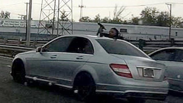 StLouis police release image of man hanging out of window to fire gun       