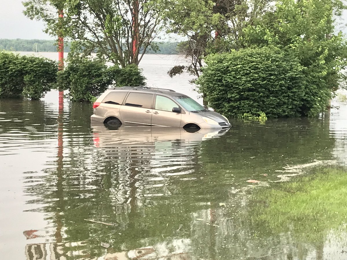 This is in West Alton at the Rt. 94 and Highway 67 intersection. Gas station parking lots look more like ponds and lakes. A van partially submerged too.