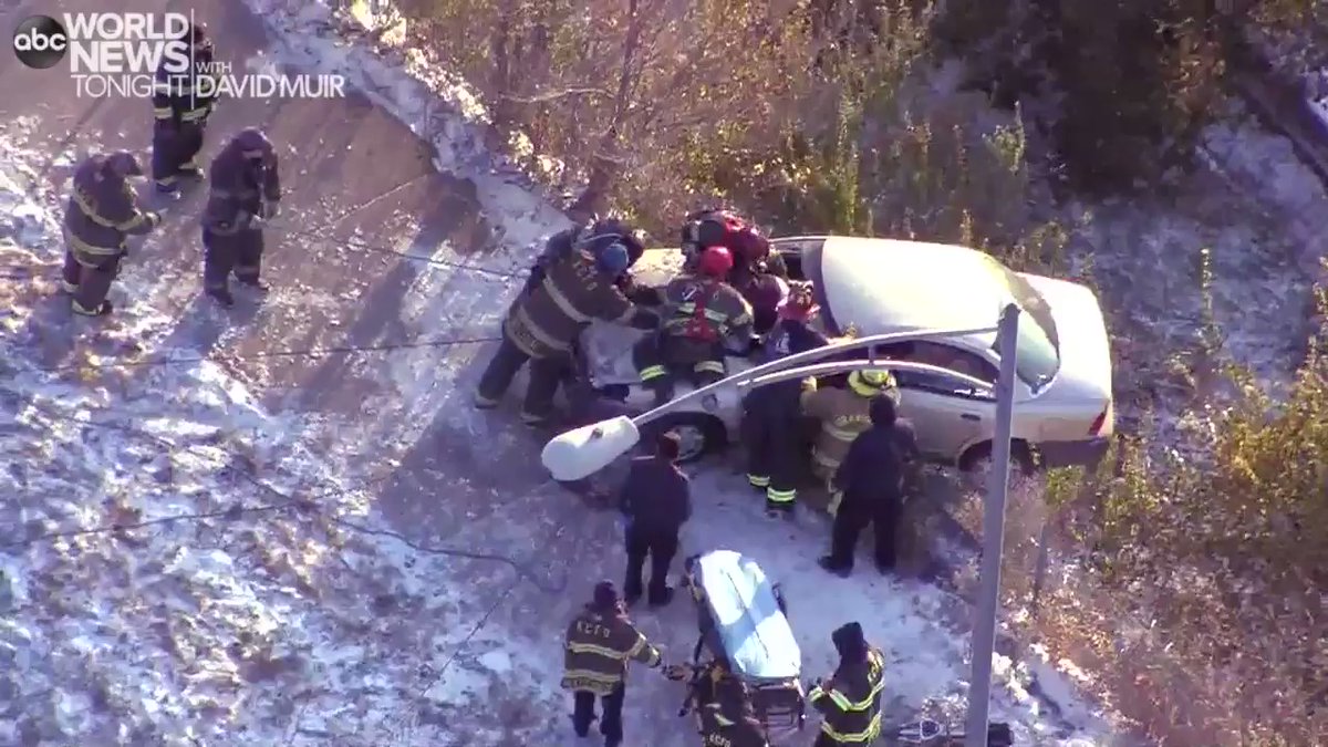 Aerial footage shows firefighters pulling a woman from a car dangling over the edge of an icy roadway in Kansas City, Missouri, after a crash as snow and cold continues to cause dangerous driving conditions from the Midwest to the Northeast